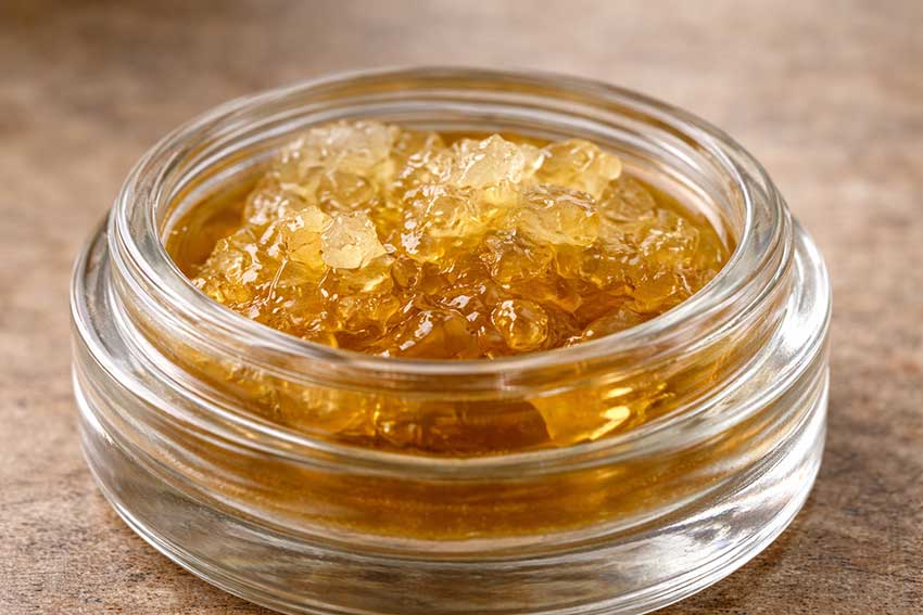 THC diamonds and sauce cannabis concentrate in a glass jar at Huff and Puff Dispensary